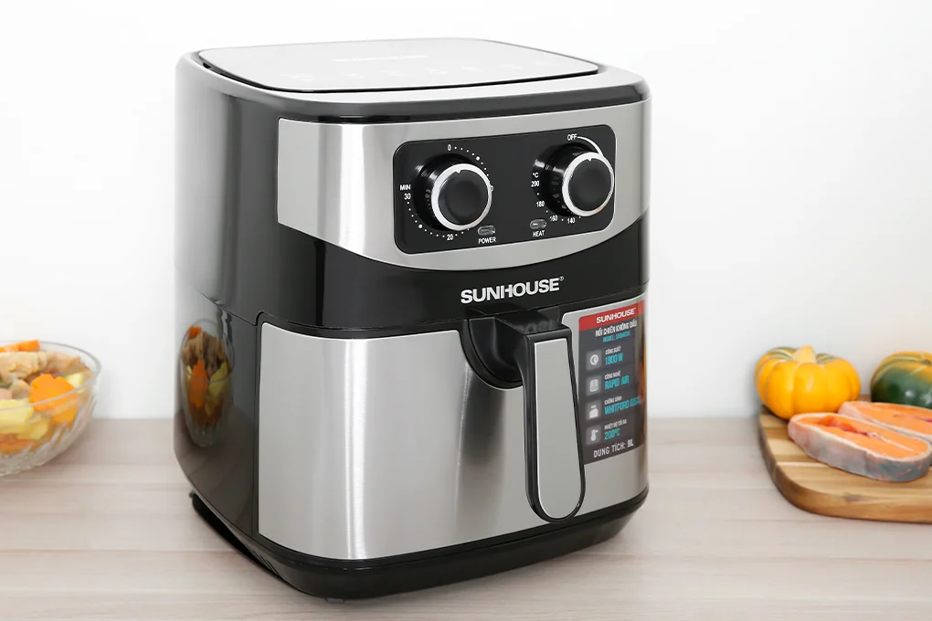 Modern air fryer with digital display and food inside